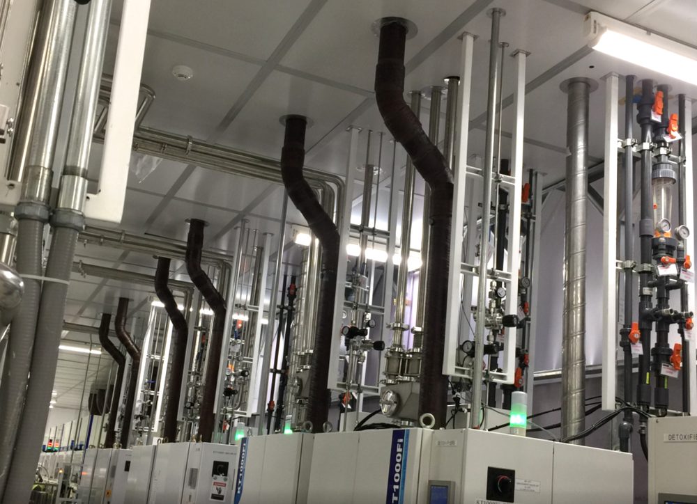 Gas panels and overhead gas-stick piping in a semiconductor cleanroom