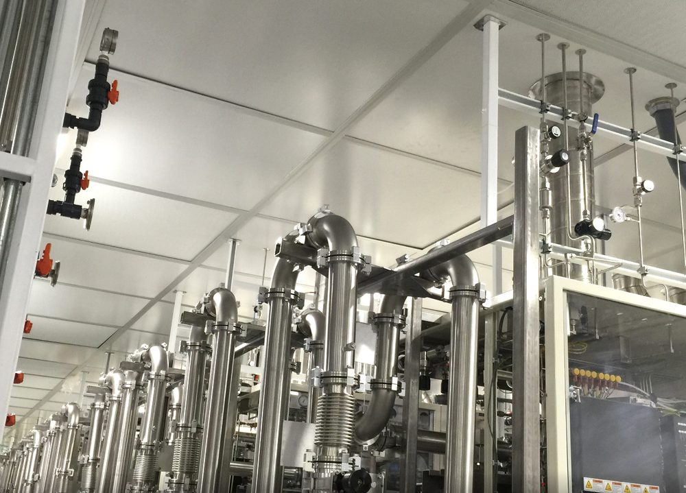Overhead stainless vacuum and bulk-gas piping installed in a semiconductor cleanroom