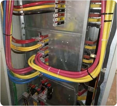 Technician tracing electrical lines during plant work