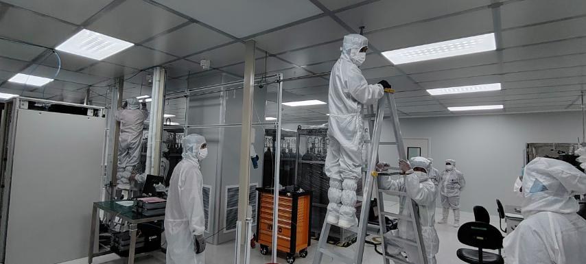 BRS crew in cleanroom gowning working from ladders across a semiconductor fab floor